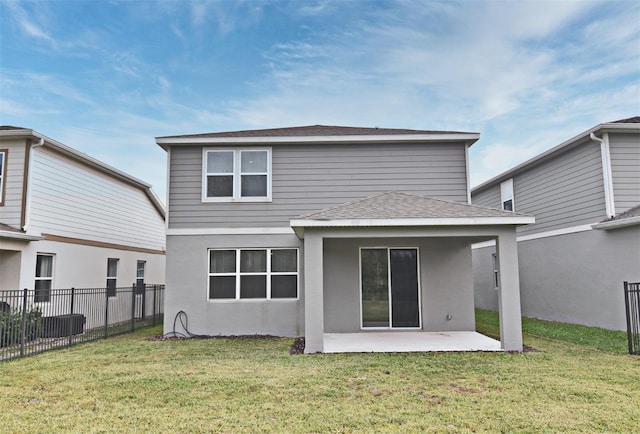 back of property featuring a patio area and a lawn