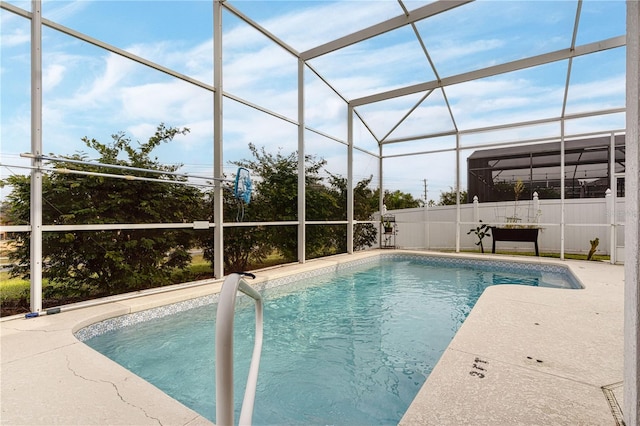 view of pool with a patio and a lanai