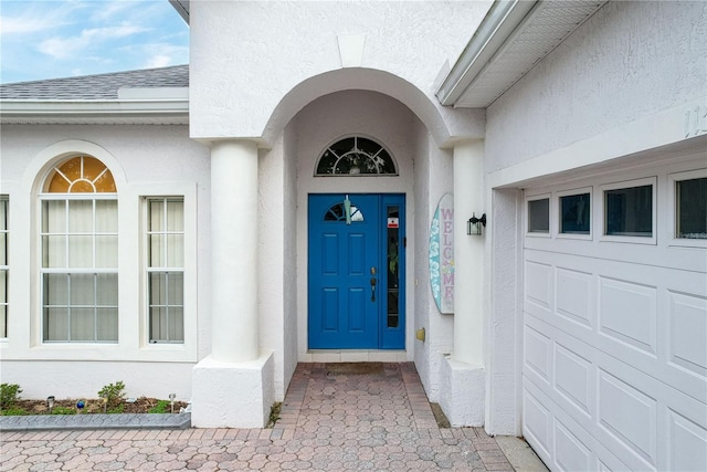 view of exterior entry featuring a garage