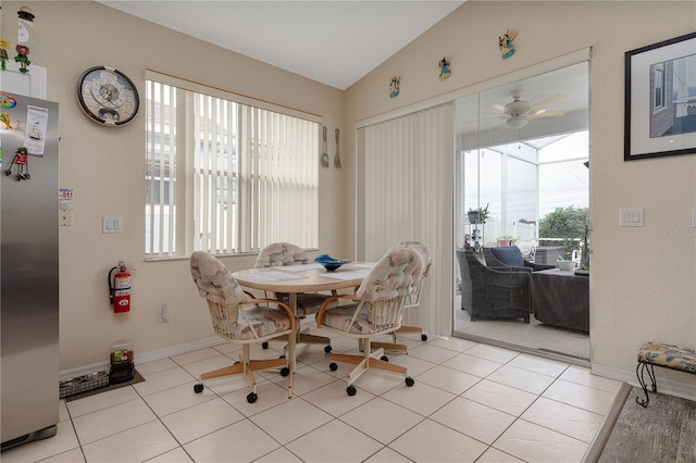 tiled dining room with lofted ceiling and ceiling fan