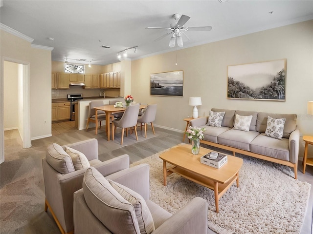 carpeted living room with ornamental molding, sink, and ceiling fan