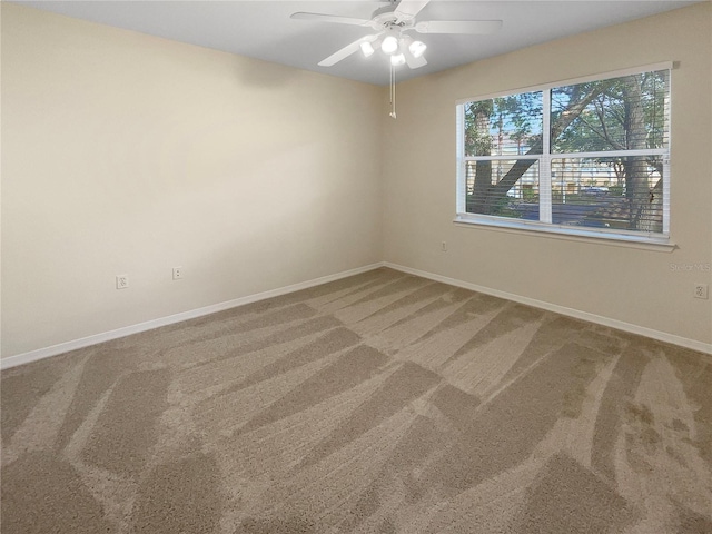 empty room featuring carpet flooring and ceiling fan