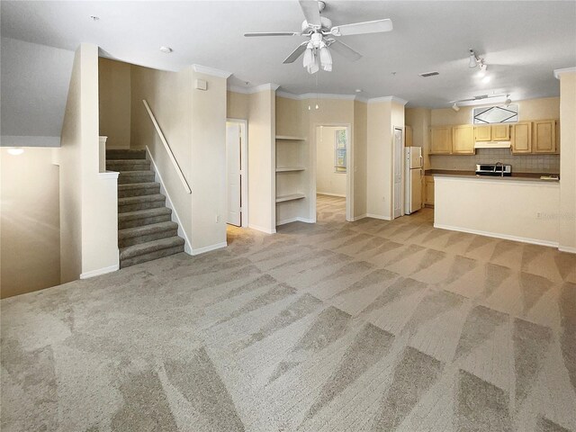 1711 Shadow View Cir Unit 1711, Maitland, FL 32751 - unfurnished living room with ornamental molding, light carpet, baseboards, ceiling fan, and stairway