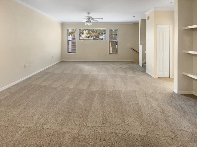 carpeted spare room with crown molding and ceiling fan