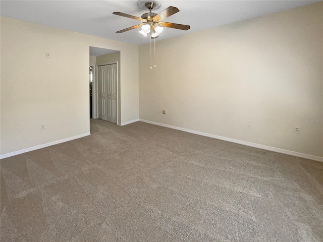 spare room with carpet floors and ceiling fan