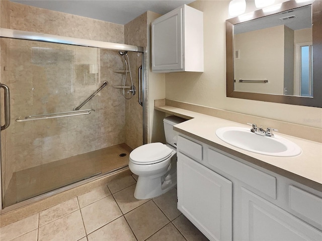 bathroom featuring vanity, a shower with shower door, toilet, and tile patterned flooring