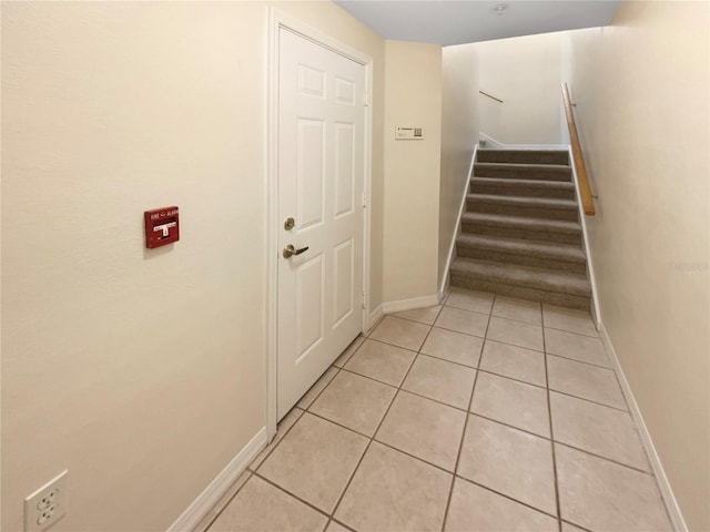 stairway featuring tile patterned flooring