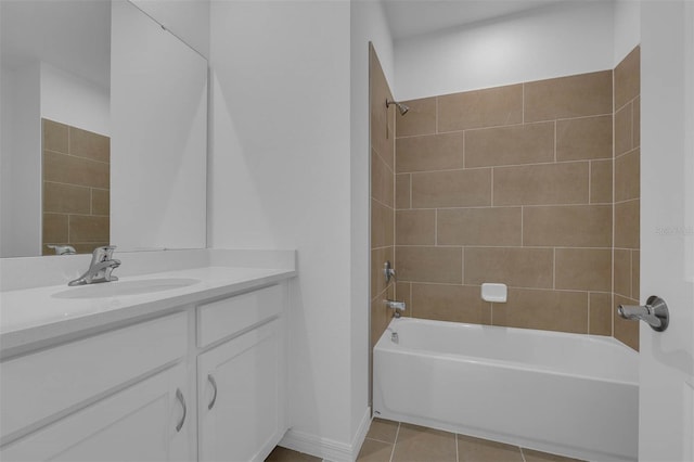 bathroom with tiled shower / bath, tile patterned floors, and vanity