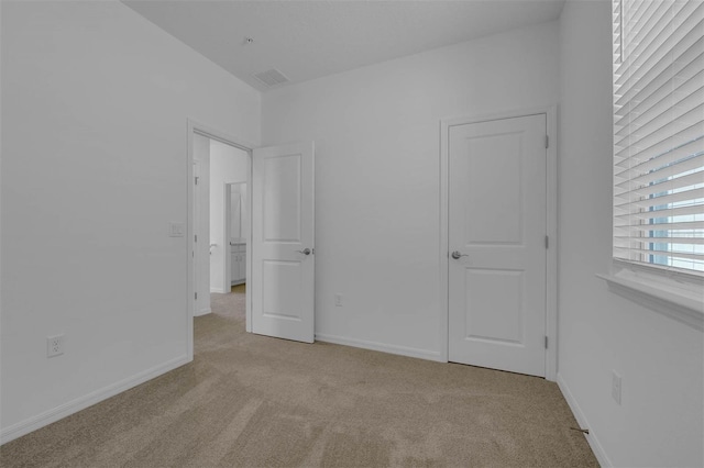 unfurnished bedroom with light carpet