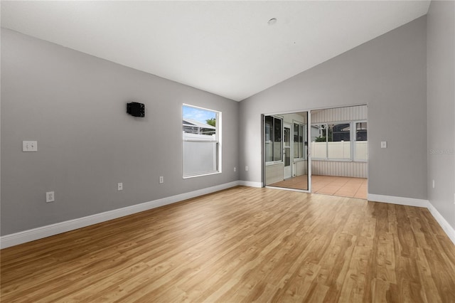 unfurnished bedroom with a closet, light hardwood / wood-style floors, and lofted ceiling