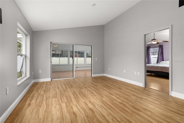 unfurnished bedroom featuring light hardwood / wood-style floors and lofted ceiling