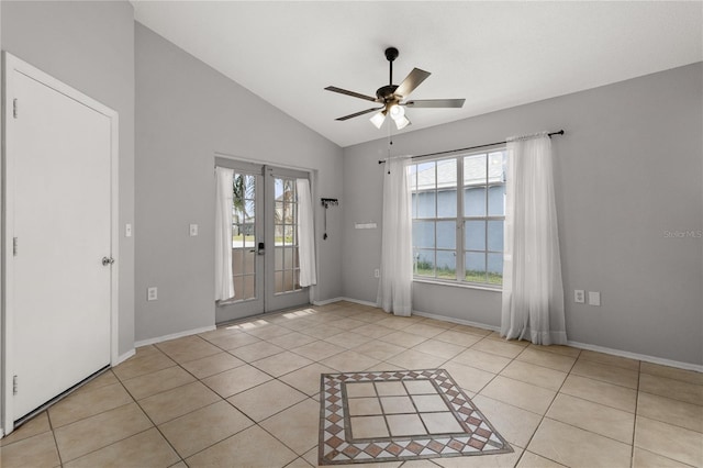 interior space with lofted ceiling, french doors, light tile patterned floors, and ceiling fan