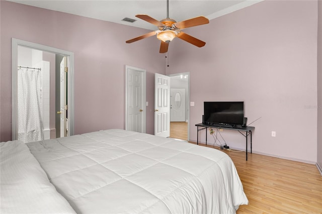 bedroom with ceiling fan, lofted ceiling, and hardwood / wood-style floors