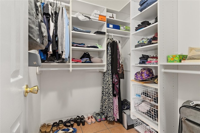 spacious closet featuring light tile patterned floors