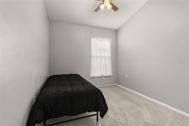 carpeted bedroom with ceiling fan and vaulted ceiling