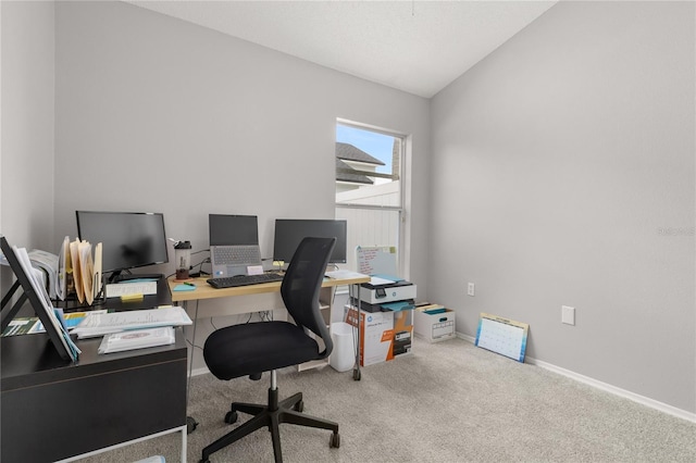 office space featuring carpet and vaulted ceiling