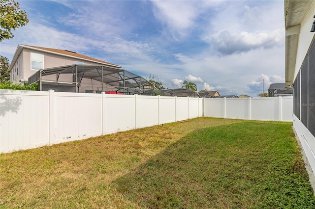 view of yard with glass enclosure