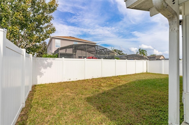 view of yard with glass enclosure