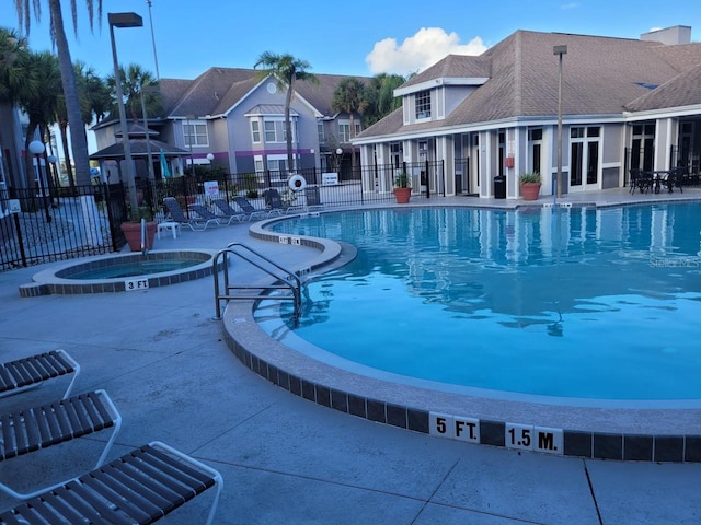 view of pool featuring a patio area and a community hot tub