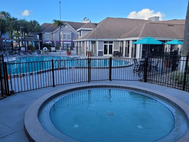 view of pool featuring french doors and a patio