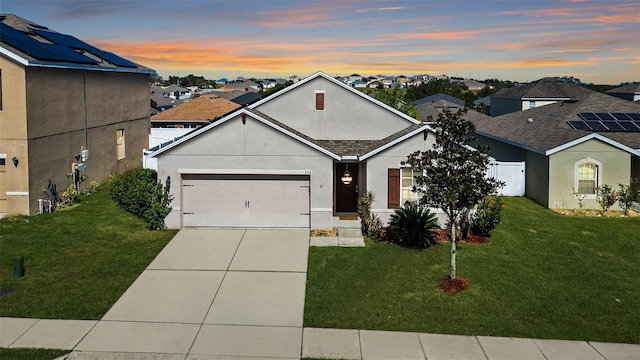 view of front of property featuring a yard and a garage