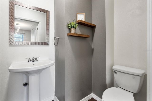 bathroom with toilet and sink