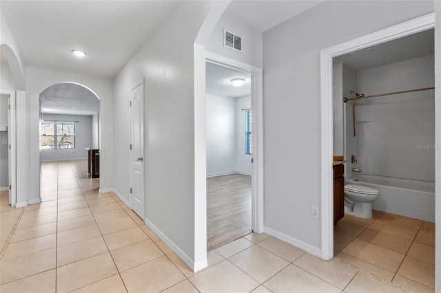 hall featuring light tile patterned flooring
