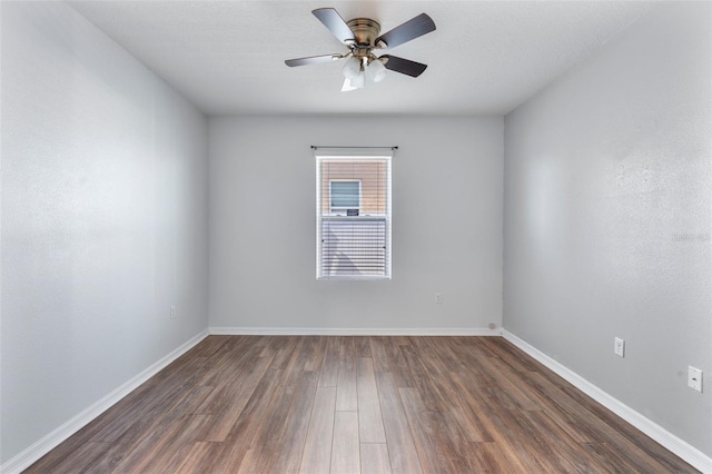 spare room featuring ceiling fan and dark hardwood / wood-style flooring