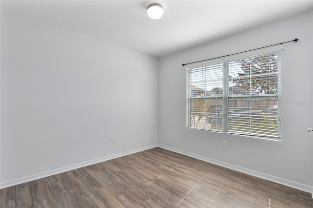 spare room featuring wood-type flooring