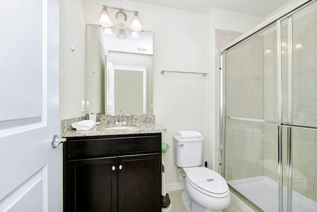 bathroom featuring a shower with door, vanity, toilet, and tile patterned flooring