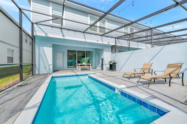 view of swimming pool with a patio and glass enclosure