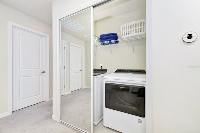 laundry area featuring independent washer and dryer and light carpet