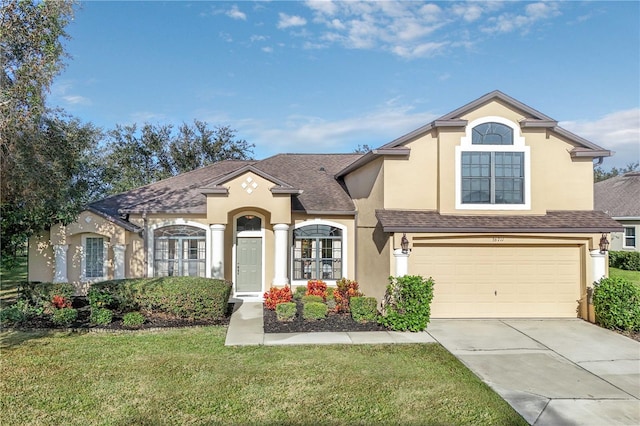 view of front of house featuring a front yard and a garage