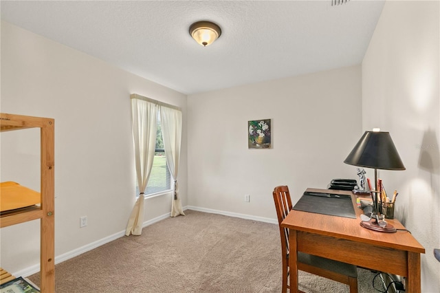 home office featuring visible vents, light carpet, a textured ceiling, and baseboards