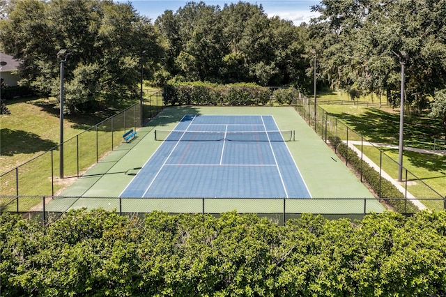 view of sport court featuring fence