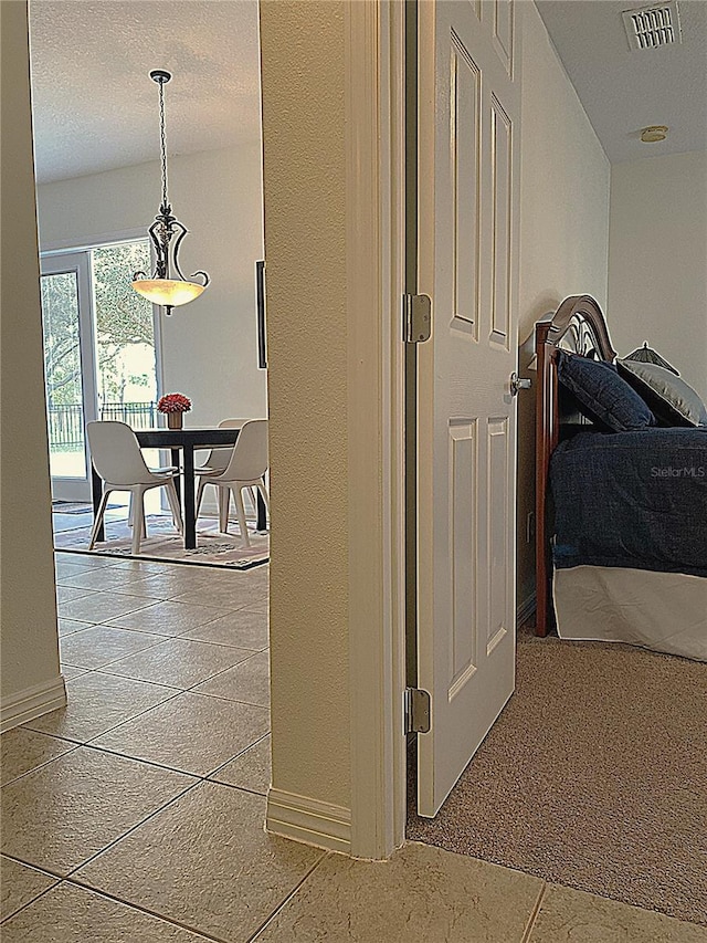 hall featuring baseboards and visible vents