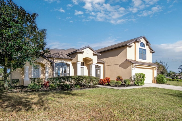 view of front of house with concrete driveway, a front lawn, an attached garage, and stucco siding