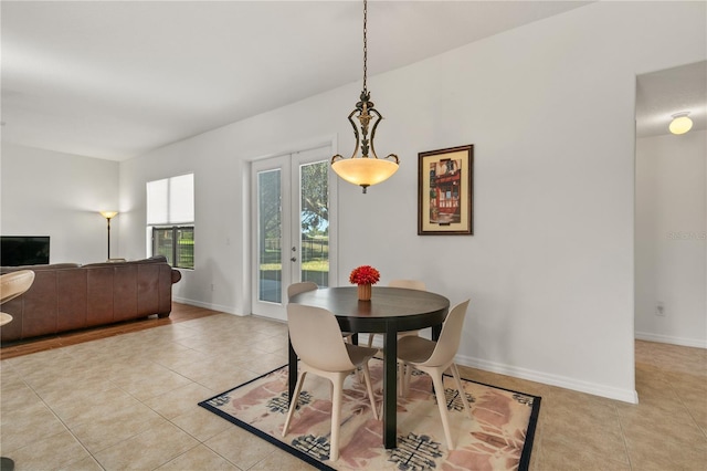 dining area featuring baseboards, french doors, and light tile patterned flooring