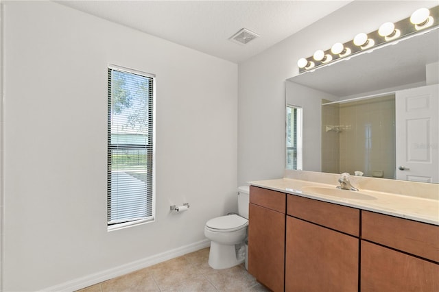 full bathroom featuring tile patterned flooring, toilet, vanity, visible vents, and a tile shower