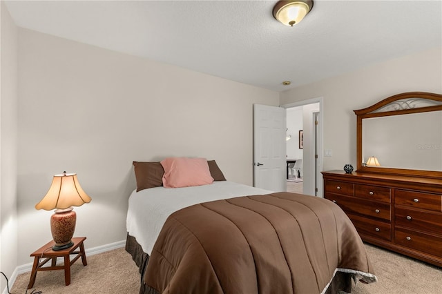 bedroom with light carpet and baseboards