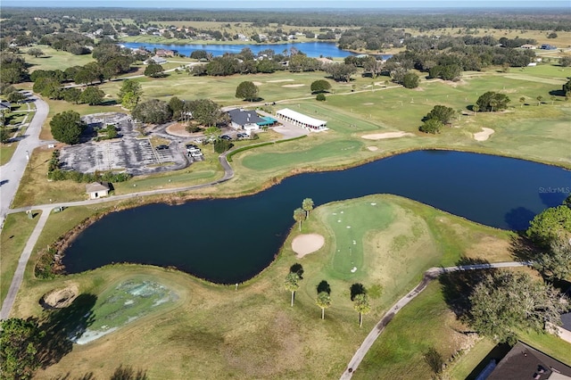 bird's eye view with view of golf course and a water view