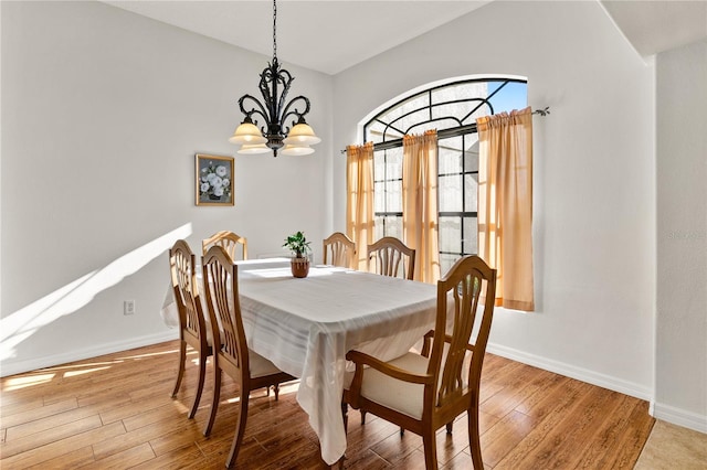 36711 Alaqua Ct, Eustis, FL 32736 - dining area featuring a chandelier, baseboards, and light wood finished floors