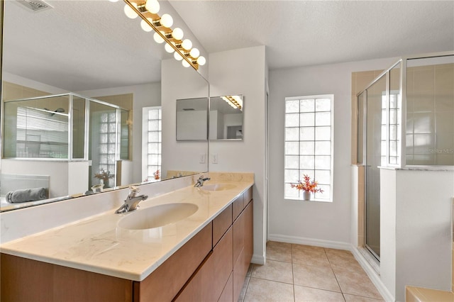 36711 Alaqua Ct, Eustis, FL 32736 - full bathroom with double vanity, healthy amount of natural light, a textured ceiling, a stall shower, and tile patterned flooring