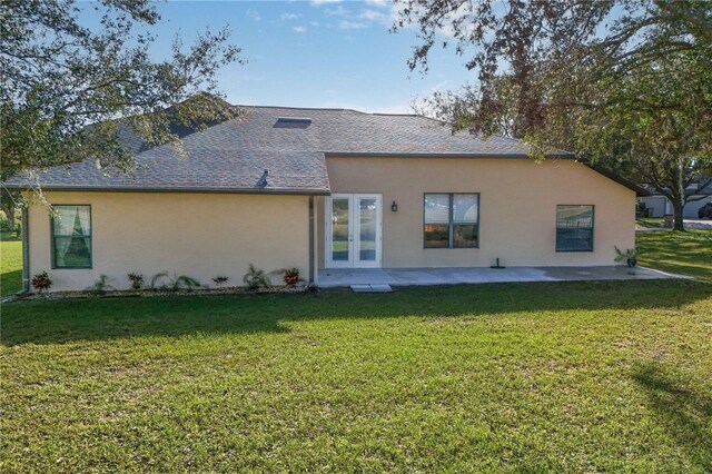 36711 Alaqua Ct, Eustis, FL 32736 - rear view of house with stucco siding, a lawn, french doors, and a shingled roof
