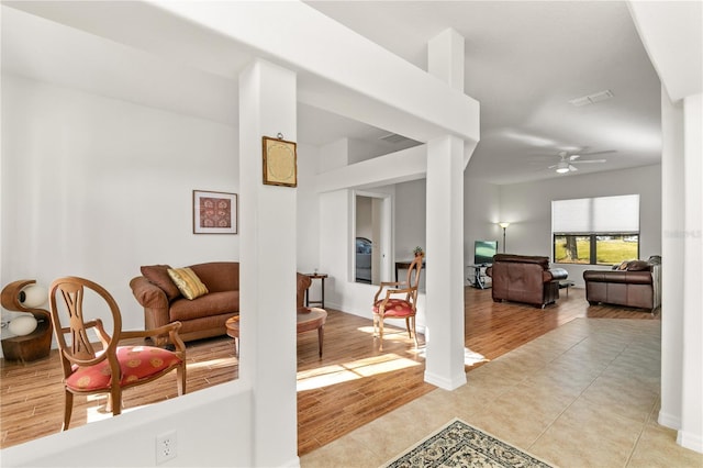 36711 Alaqua Ct, Eustis, FL 32736 - living area featuring a ceiling fan, light wood-style flooring, and baseboards