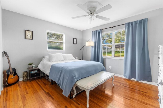 bedroom with hardwood / wood-style flooring and ceiling fan