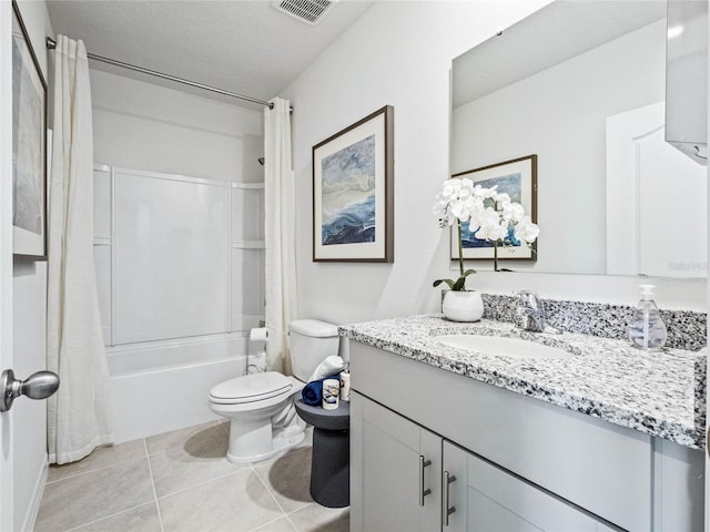 full bathroom with tile patterned floors, shower / bath combo, toilet, vanity, and a textured ceiling