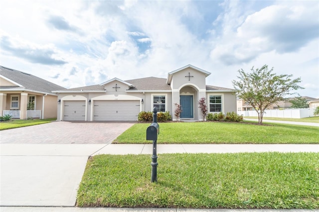 view of front of property with a front yard and a garage