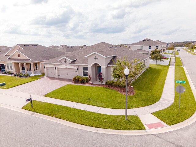 view of front of home with a front yard and a garage