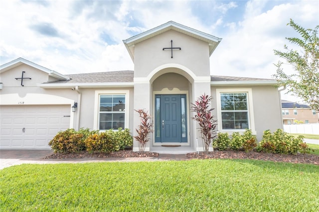 view of front facade with a garage and a front lawn